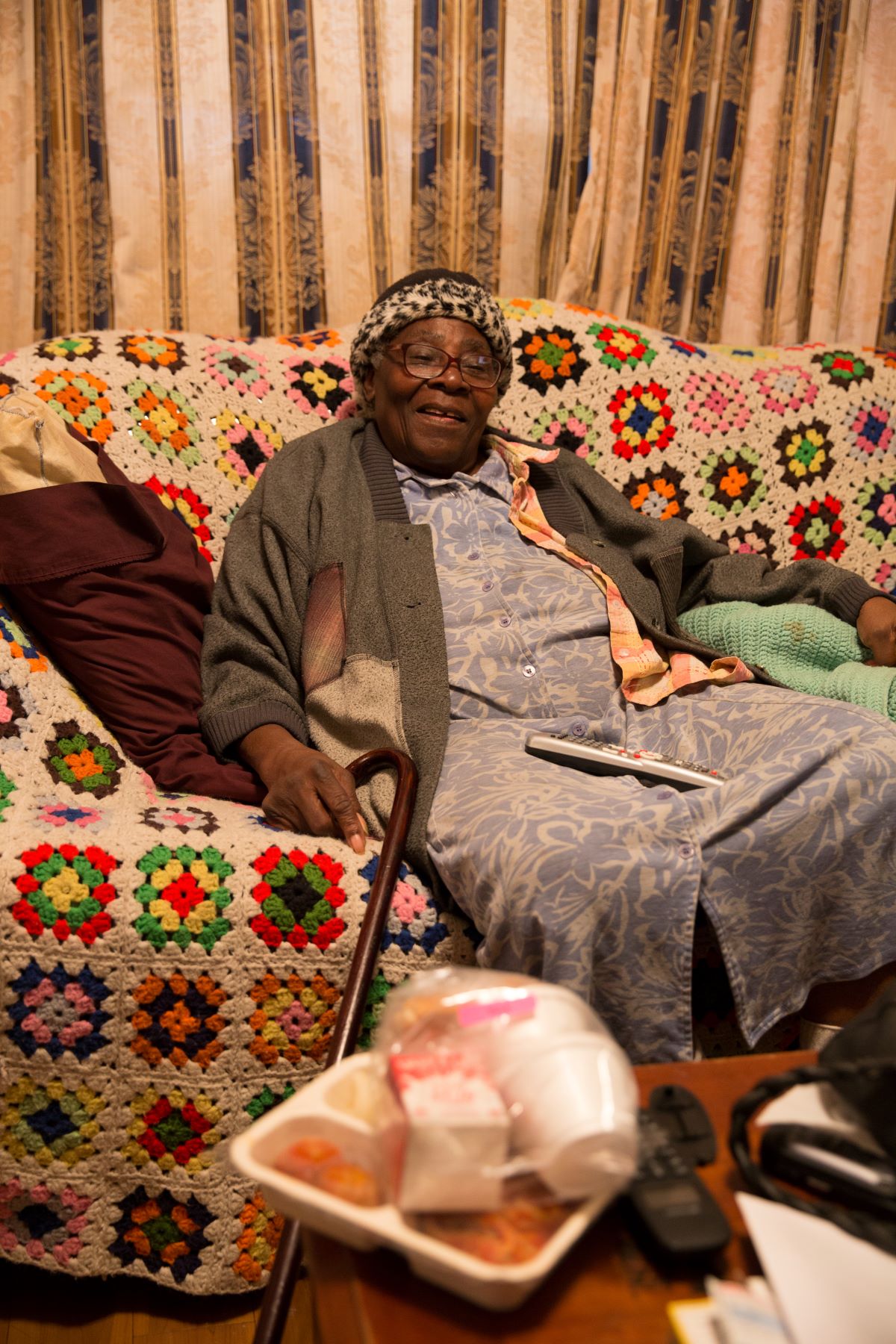 Participant on couch with meal