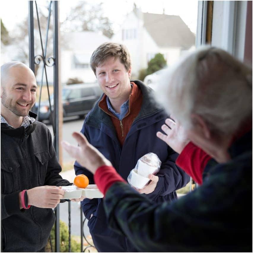 Meals on Wheels Volunteers delivering meal to participant's home